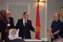 Neal Perdue serves first piece of cake to Col. Graham, second piece to Andy de Haan (oldest Marine) and third piece to Mark Patton (youngest Marine)